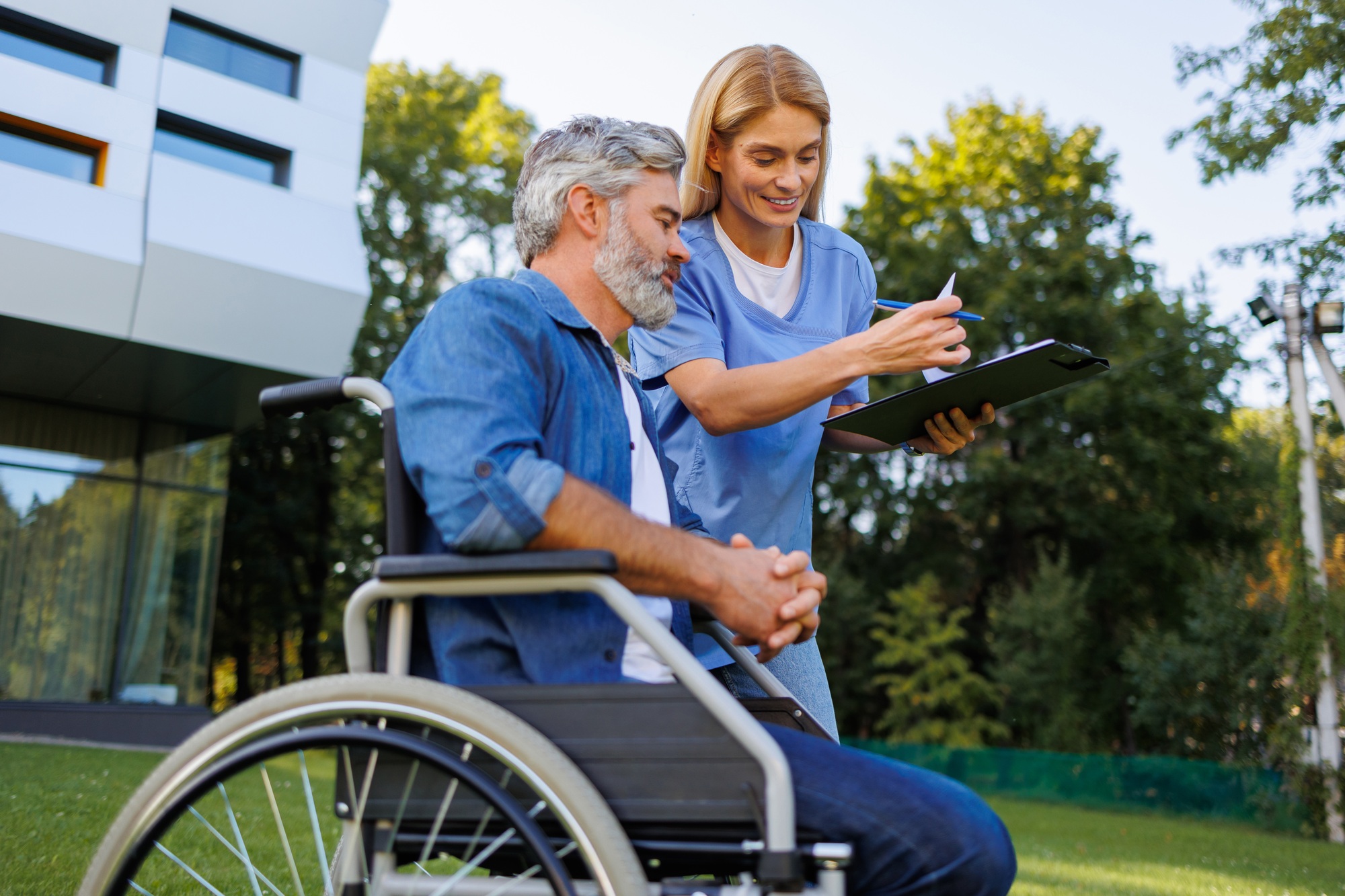 Technology in Care: Nurse Assists Patient Outdoors